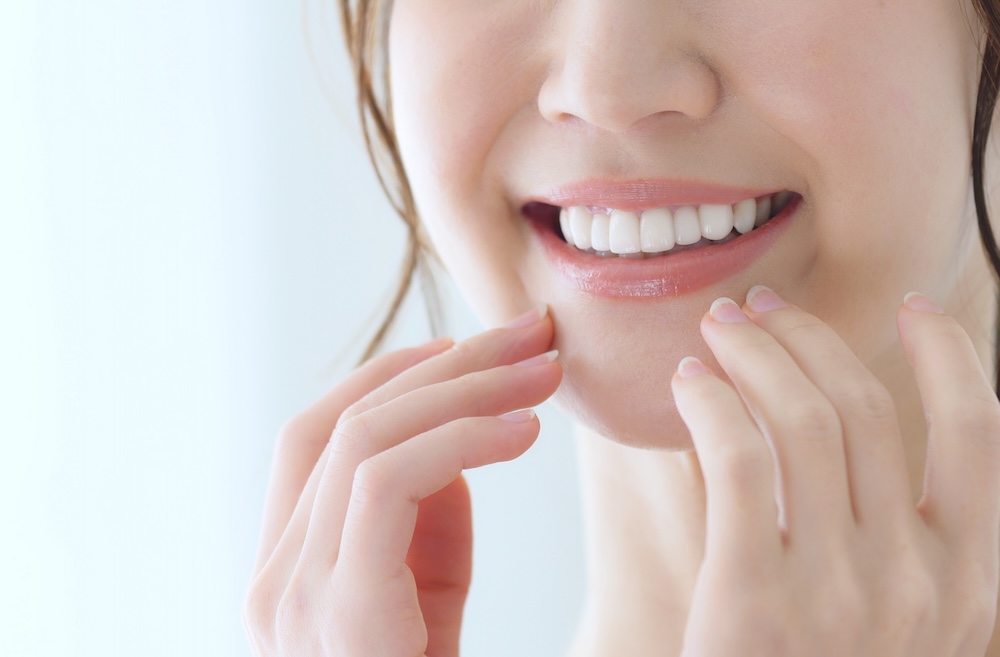 woman with perfect teeth smiling - Dentures in Puyallup