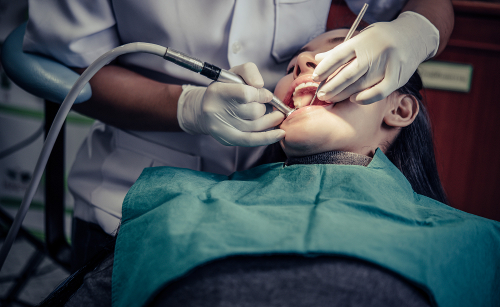 A patient undergoing a dental checkup with tools in use - Puyallup Dentist A patient undergoing a dental checkup with tools in use - Puyallup Dentist